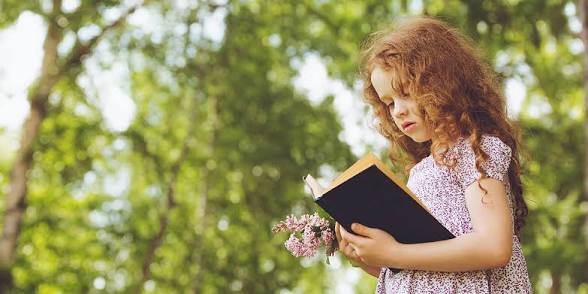 Child reading outdoors